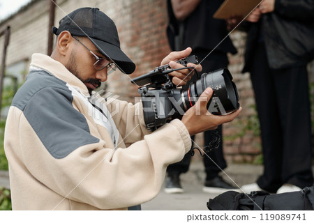 Filming Outdoors with a Professional Video Camera Filming Outdoors with a Professional Video Camera 119089741