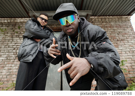 Posing in Trendy Streetwear with Reflective Sunglasses Posing in Trendy Streetwear with Reflective Sunglasses 119089788