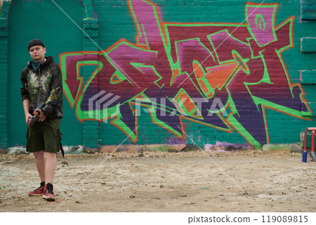 Graffiti artwork on wall and male artist 119089815