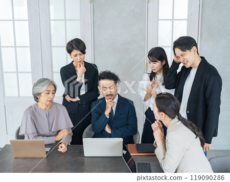 A team of business people of various ages struggling in the office 119090286