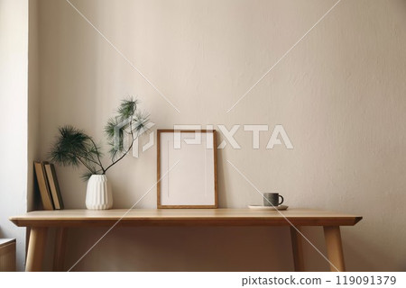 Elegant Christmas interior. Winter home still life. Scandinavian decor. Blank vertical thin picture frame mockup, cup of coffee tea. Wooden desk, table. Pine tree branches, vase. Beige wall background 119091379