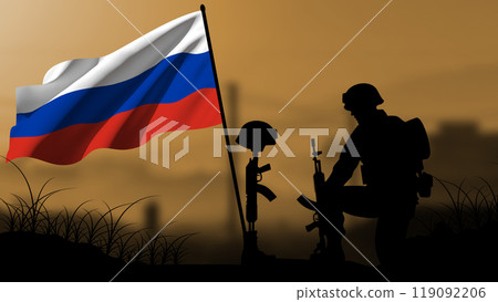 The silhouette of a Russian soldier weeps for the loss of a comrade in battle, with a large flag waving The silhouette of a Russian soldier weeps for the loss of a comrade in battle, with a large flag waving 119092206