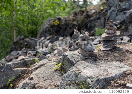 Stone cairns stand on rocky ground of former marble quarry Stone cairns stand on rocky ground of former marble quarry 119092339