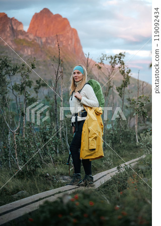 A Female Hiker in Nature Relishing the Beauty of Exploring Scenic Mountain Trails with a Backpack A Female Hiker in Nature Relishing the Beauty of Exploring Scenic Mountain Trails with a Backpack 119092434