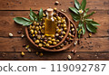 Jojoba oil and jojoba plant in wooden plate on wooden backgrounds 119092787