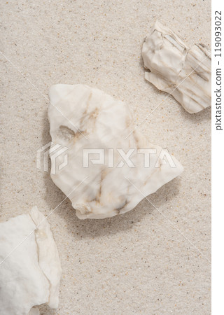 Natural background. White rocks on the sand. 119093022