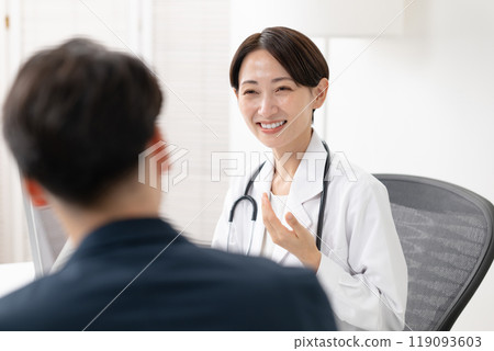 A man receiving counseling from a female doctor A man receiving counseling from a female doctor 119093603