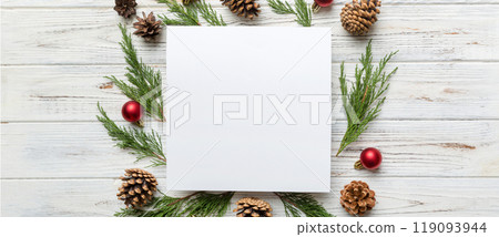 Flat lay Christmas composition. square Paper blank, pine tree branches, christmas decorations on Colored background. Top view, copy space for text 119093944