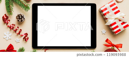 Digital tablet mock up with rustic Christmas decorations for app presentation top view with empty space for you design. Christmas online shopping concept. Tablet with copy space on colored background 119093988