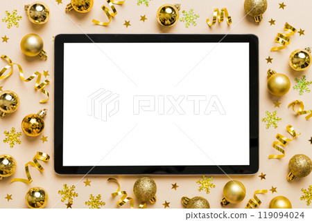 Christmas online shopping from home tablet pc with blank white display top view. Tablet with copy space on colored background with Christmas decorations balls,. Winter holidays sales background 119094024