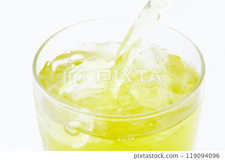 Close-up of cold green tea pouring into a glass 119094096