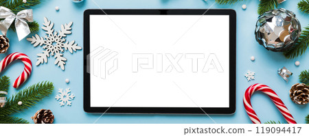 Top view of empty tablet on Christmas background made of new year decorand festive decorations. New year holiday concept. Mockup Top view of empty tablet on Christmas background made of new year decorand festive decorations. New year holiday concept. Mockup 119094417