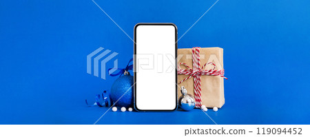 Digital phone mock up with rustic Christmas decorations for app presentation with empty space for you design. Christmas online shopping concept. Tablet with copy space on colored background Digital phone mock up with rustic Christmas decorations for app presentation with empty space for you design. Christmas online shopping concept. Tablet with copy space on colored background 119094452