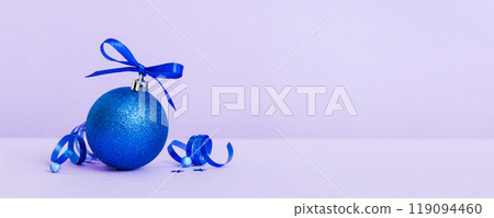 Christmas ball on colored background. decoration bauble with ribbon bow with copy space Christmas ball on colored background. decoration bauble with ribbon bow with copy space 119094460