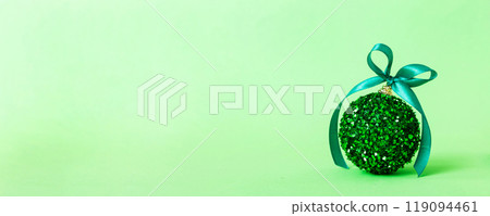 Christmas ball on colored background. decoration bauble with ribbon bow with copy space 119094461