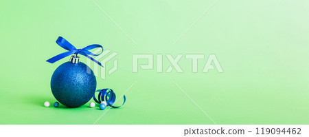 Christmas ball on colored background. decoration bauble with ribbon bow with copy space Christmas ball on colored background. decoration bauble with ribbon bow with copy space 119094462