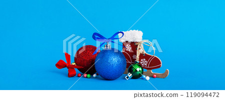 Christmas ball with skates on colored background. decoration bauble with ribbon bow with copy space Christmas ball with skates on colored background. decoration bauble with ribbon bow with copy space 119094472
