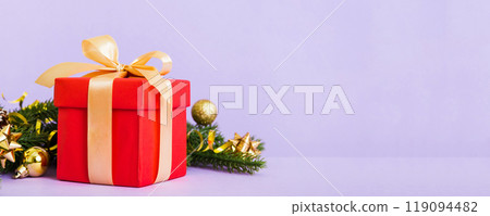 New Year Christmas mood, gift box, branches of a christmas tree, New Year decorations on a colored background New Year Christmas mood, gift box, branches of a christmas tree, New Year decorations on a colored background 119094482