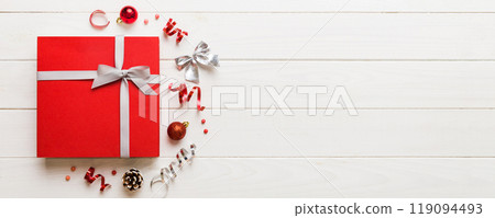 Top view Flat lay Christmas decorations and gift box on colored background with copy space. Christmas or Happy New Year composition Top view Flat lay Christmas decorations and gift box on colored background with copy space. Christmas or Happy New Year composition 119094493