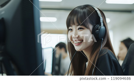 Businesswoman wearing a headset and responding in the office 119094686