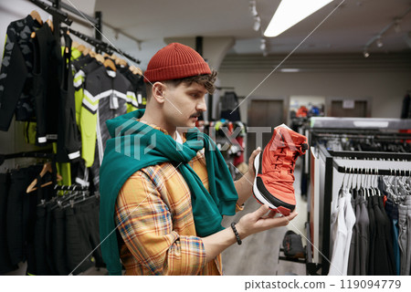 Man choosing sports sneakers shoes at sports shop store Man choosing sports sneakers shoes at sports shop store 119094779