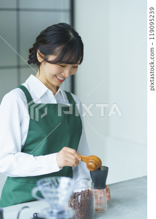 A young female sales clerk brewing coffee on a weekend morning A young female sales clerk brewing coffee on a weekend morning 119095239