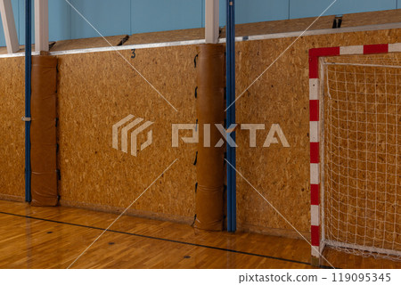 Indoor Handball Court with Goal Post and Wooden Walls in Gymnasium. Indoor Handball Court with Goal Post and Wooden Walls in Gymnasium. 119095345