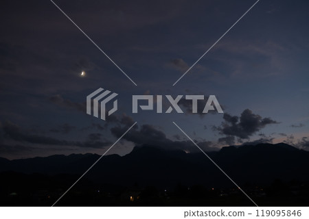Hakushu Town, Hokuto City, evening sky in the month of Fumizuki, the moon at 6.7 days of age hanging over Mount Kaikoma in the Southern Alps Hakushu Town, Hokuto City, evening sky in the month of Fumizuki, the moon at 6.7 days of age hanging over Mount Kaikoma in the Southern Alps 119095846