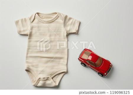 Baby boy beige onesie on light background. Fashion newborn clothes. Flat lay, top view. Baby kids soft clothing set, toy car. Infant trendy bodysuit made of organic eco friendly cotton. Gender neutral 119096325