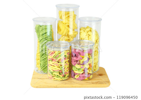 Storing different types of pasta at home. Varieties of multi-colored pasta in glass containers. Types of uncooked pasta. Isolate on a white background. 119096450