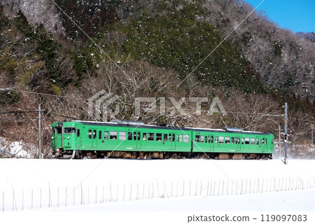 JR West 113 series train running through snowy winter scenery on the Maizuru Line 119097083