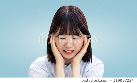 Young business woman holding her head and worrying 119097224