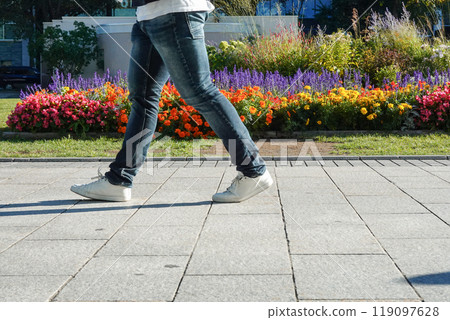 The feet of people walking down the street 119097628