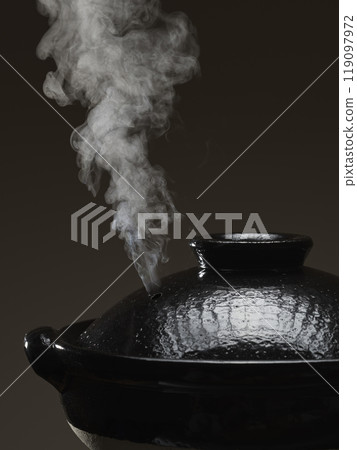 Image of hot pot cooking with steam rising from the clay pot 119097972