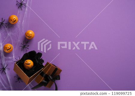 Halloween Mini pumpkins and spiders with spider webs in gift box on purple background. Background for Halloween cards, banners, invitations. Place for your text. 119099725