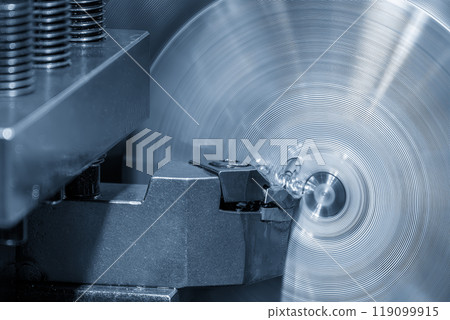 Closeup scene the lathe machine finish cut the metal parts by lathe tools in the light blue scene. Closeup scene the lathe machine finish cut the metal parts by lathe tools in the light blue scene. 119099915