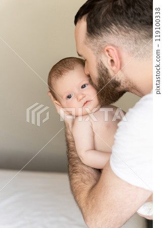 Bearded man young parent holding rocking child daughter or son in hands 119100338