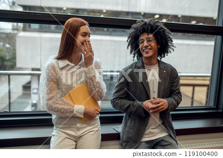 Young people talking, smiling and looking involved Young people talking, smiling and looking involved 119100400