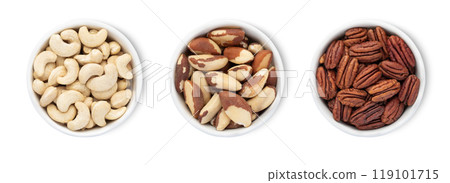 Bowl plates with brazil nuts and pecan nuts and cashew isolated on white background.Top view. 119101715