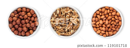 Bowl plates with hazelnut and walnut and peanut nuts isolated on white background.Top view. 119101718