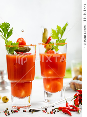 Bloody mary glasses with celery,olives,red hot pepper and cocktail spoon on light bar background. Bloody mary glasses with celery,olives,red hot pepper and cocktail spoon on light bar background. 119101724
