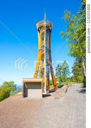 The Hamstejn lookout tower stands tall with a spiral staircase and steel structure, blending architecture and nature. Visitors can enjoy panoramic views of the picturesque Bohemian Paradise. 119101808
