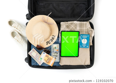Travel background. Open Suitcase with summer cloth, hat, passports on the cloth background. High quality photo. Woman's hands packing suitcase for a journey on the white background. Travel Travel background. Open Suitcase with summer cloth, hat, passports on the cloth background. High quality photo. Woman's hands packing suitcase for a journey on the white background. Travel 119102070