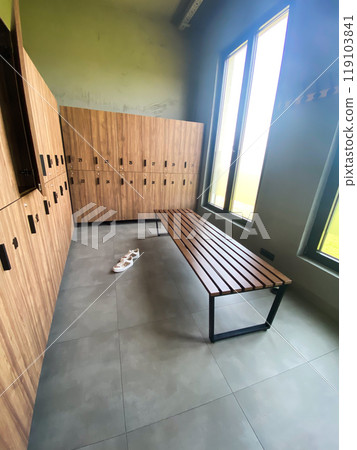 Wooden bench in empty locker room at gym 119103841