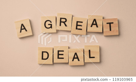 Word of A Great Deal. Text written by wood toy or wood cubes on white paper background Word of A Great Deal. Text written by wood toy or wood cubes on white paper background 119103965