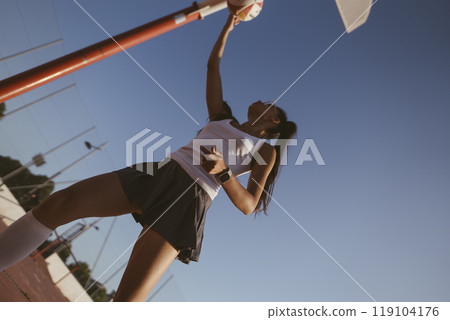 An Athlete Engaged in Intense Training with a Basketball Under a Beautiful Clear Sky An Athlete Engaged in Intense Training with a Basketball Under a Beautiful Clear Sky 119104176