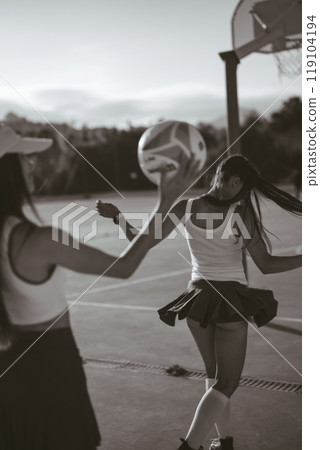 Energetic and Enthusiastic Cheerleaders Performing in Action with a Basketball on the Court Energetic and Enthusiastic Cheerleaders Performing in Action with a Basketball on the Court 119104194