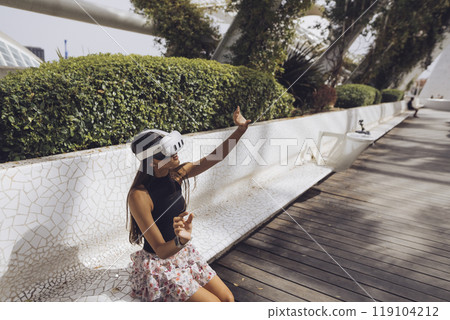 A Young Woman Filled with Joy, Enjoying Leisure Time Outdoors in Natures Embrace 119104212