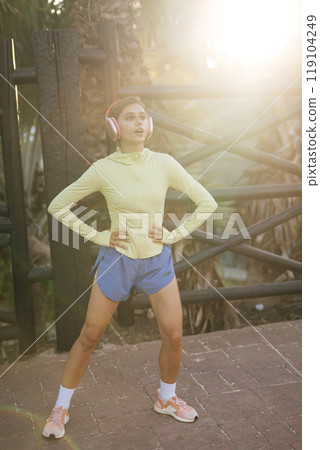 An Active Young Woman Dressed in Stylish Athletic Gear Enjoying the Outdoors and Nature 119104249