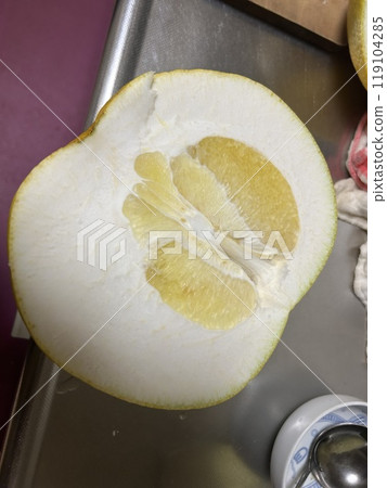This is a pomelo, a large citrus fruit cut in two. 119104285